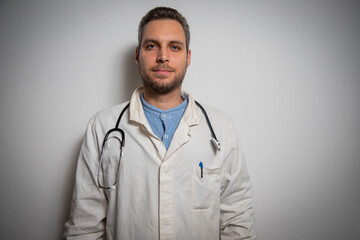 Healthcare practitioner standing in the studio with a stethoscope at his neck