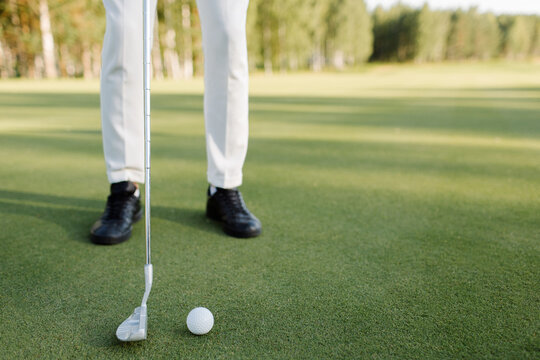 Close-up of male legs and clubs on a golf course. High quality photo