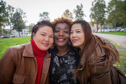 Group of happy smiling multiracial having fun at the city park. Friendship concept