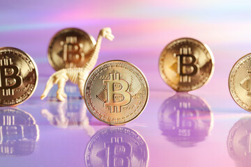 Golden bitcoin coins with dinosaur on neon background. digital currency, business style. Mining and...