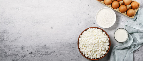 Cottage curd cheese in a wooden bowl on grey marble table.