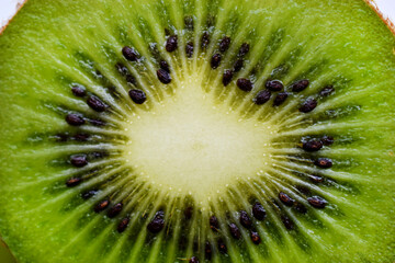 Green and juicy kiwi fruit close-up. Juicy tropical fruit kiwi macrophoto.