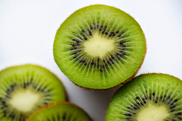 Fototapeta na wymiar Green and juicy kiwi fruit close-up. Juicy tropical fruit kiwi macrophoto.