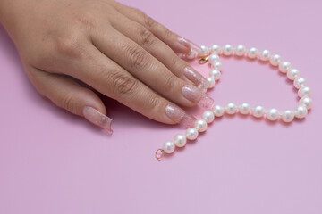 stylish women's manicure , beautiful women's hands on a pink background