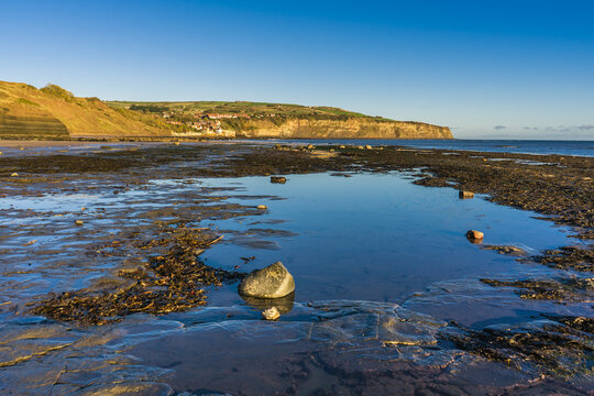 Looking along the beach towards Robin Hoods Bay from Boggle Hole at low tide.