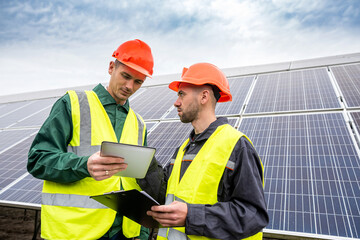young hardy men in overalls arrived to discuss a plan to install solar panels.
