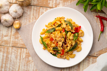 Stir-Fried Minced chicken breast and Basil with elbow macaroni,Pad Kra Pao,Thai fusion food.Top view