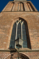 The gothic tower of the Maria Church in the town of Vollenhove, Overijssel, the Netherlands, from a low perspective
