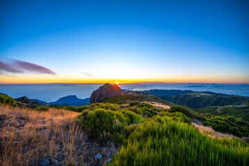 Madeira sunrise photographed from the beautiful mountain landscape of Pico do Ariero. Pico do...