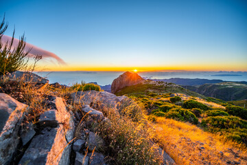 Madeira sunrise photographed from the beautiful mountain landscape of Pico do Ariero. Pico do...