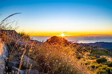 Madeira sunrise photographed from the beautiful mountain landscape of Pico do Ariero. Pico do...