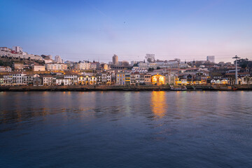 Fototapeta premium Vila Nova de Gaia skyline and Douro River at sunset - Porto, Portugal