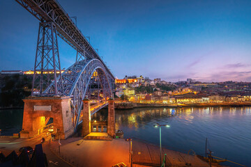 Illuminated Dom Luis I Bridge, Vila Nova de Gaia skyline and Douro River at sunset
