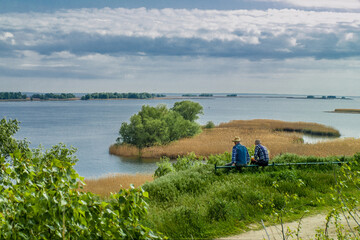 Two people on the river bank