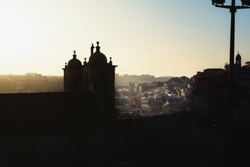 Obraz premium High angle view of Porto City at sunset with Igreja dos Grilos (Church of St. Lawrence) silhouette - Porto, Portugal
