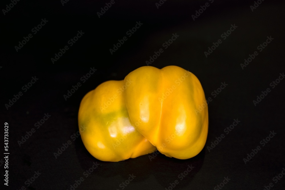 Poster Yellow bellpepper or capsicum isolated on black background