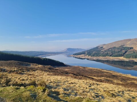 Carron Valley Reservoir under the clear sky in Scotland