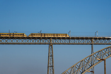 Yellow train at Dom Luis I Bridge - Porto, Portugal