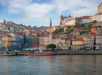 Fototapeta premium Porto Skyline, Cais da Ribeira and Douro River with Clerigos Tower and Se do Porto Cathedral - Porto, Portugal
