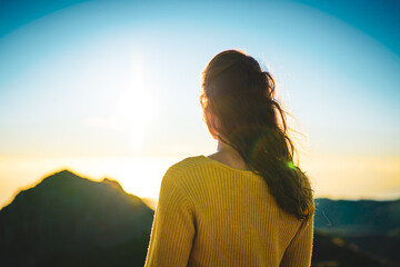 Woman enjoying beautiful mountain landscape of Pico do Ariero during sunrise. Pico do Arieiro,...