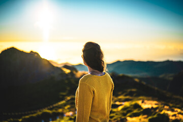 Woman enjoying beautiful mountain landscape of Pico do Ariero during sunrise. Pico do Arieiro,...