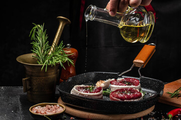 Fototapeta na wymiar Chef cooking steak on grill pan with rosemary and spices. Beef medallions wrapped in bacon. Culinary, cooking concept, Long banner format