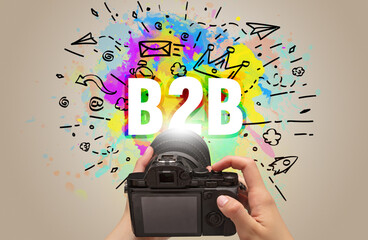 Close-up of a hand holding digital camera with abstract drawing
