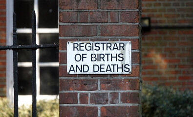 Registrar of Births and Deaths sign on a wall. 