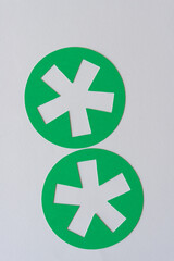 Obraz premium two green round shapes with asterisk cutouts