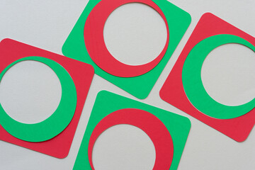 red and green paper frames with circle and square shapes