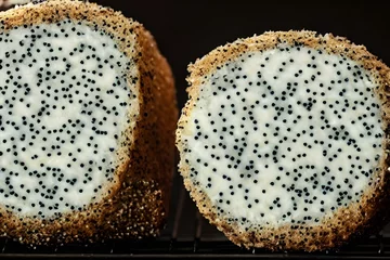 Poster AI-generated hyper-realistic cheesecake with chia seeds on the black background © Omer Mendes/Wirestock Creators