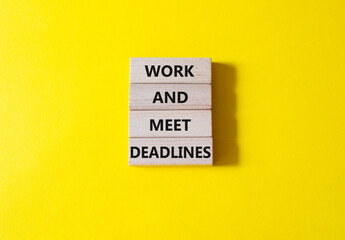 Work and deadline symbol. Concept words Work and meet deadlines on wooden blocks. Beautiful yellow background. Business and Work and meet deadlines concept. Copy space.