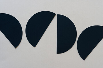 cut black paper semi circle shapes on blank paper
