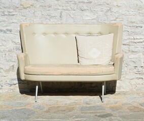 Light colored double seat couch with cushion