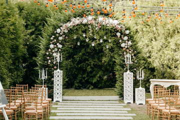 Italian wedding decoration. Green eucalyptus, oranges and pink flowers decorate wedding altar