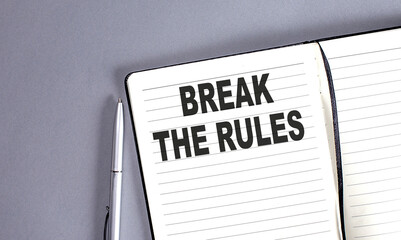 BREAK THE RULES word on the notebook with pen