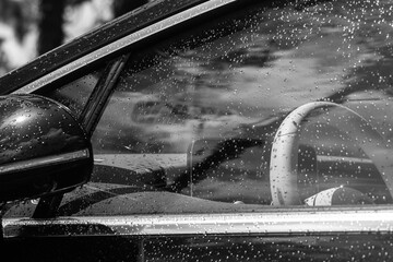 steering wheel through a rainy car window 