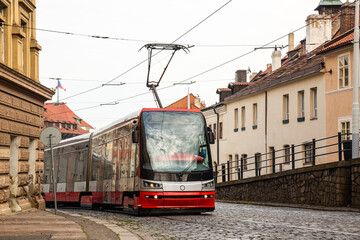 Modern Tram in old stree of Prague in a summer day, Czech Republic. The Prague tram network is the...