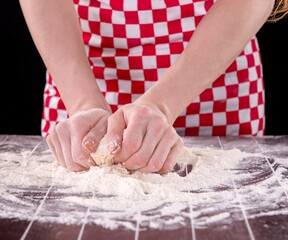 Cook preparing dough for baking in the kitchen