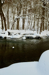 Chilly cold winter river and snowy mountains