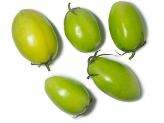 Green tomatoes on a white background. The concept of an unripe vegetable. Salt preparation. Salting product. Healthy food. Place for writing text. An unripe fruit picked from a bush.