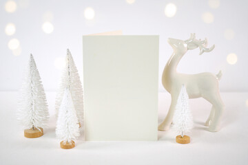 Christmas 5x7 vertical greeting card, party invitation mockup, styled with white reindeer and mini...