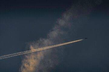 plane trails seen in the sky during sunset