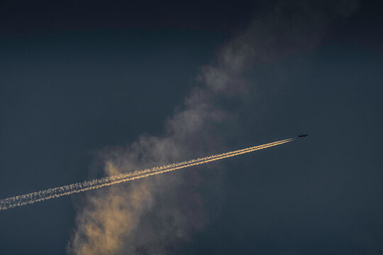 Plane Trails Seen In The Sky During Sunset