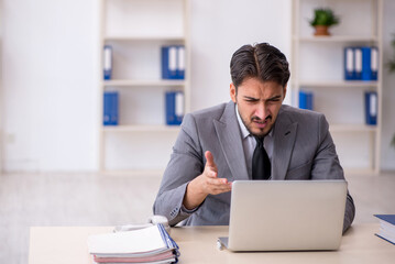 Young male employee working in the office