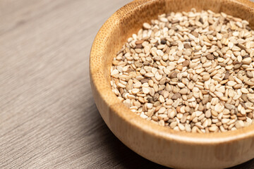 wooden bowl filled with sesame seeds