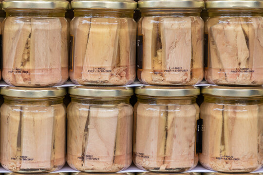 fillets of white tuna preserved with olive oil in glass jar. food preservation concept