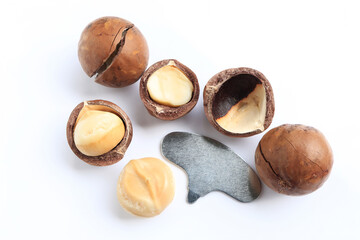 Close up of Shelled and unshelled organic macadamia nuts isolated on white background. healthy food concept.