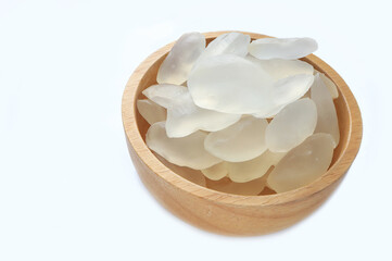 Candy palm seed, Close up of palm seed, palm fruit seeds or Arenga pinnata in wooden bowl on white background.