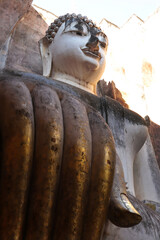 A Buddha statue at Wat Si Chum in the precinct of Sukhothai Historical Park. UNESCO World Heritage Site in Thailand.